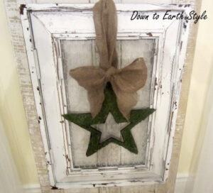 Hung on an old door with a moss wreath tied to it.