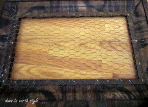 chicken wire on the back of a vintage frame for a message board.