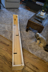 Showing the bottom side of the mantel put together with corner brackets.