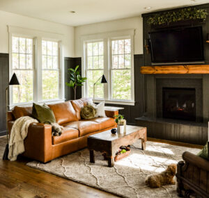 Warm wood mantel with camel leather sofa and Urbane Bronze wall.