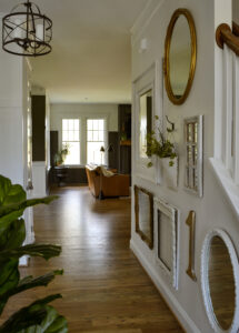 Vertical view from the front door to the living room with the gallery wall on the right.