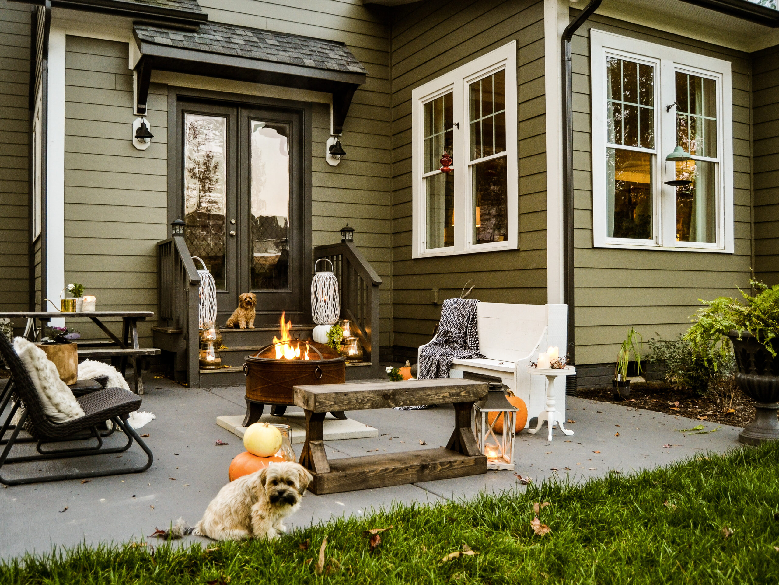 view of painted concrete patio with benches around the fire bowl.