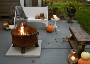 Home Depot fire bowl with candles and pumpkins and Mazi.