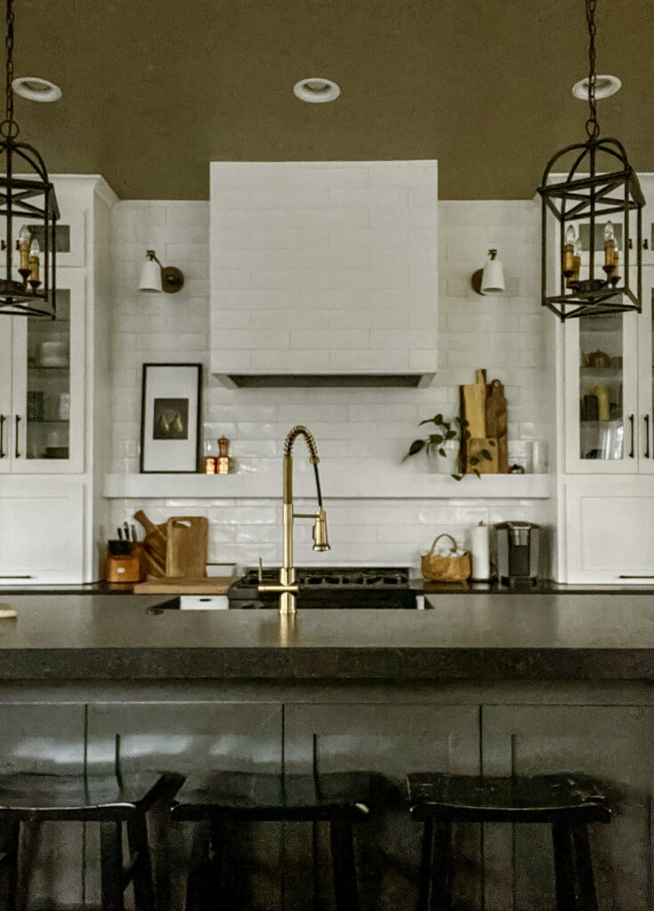 Closer view of the center sink and new tile hood the reaches the ceiling.